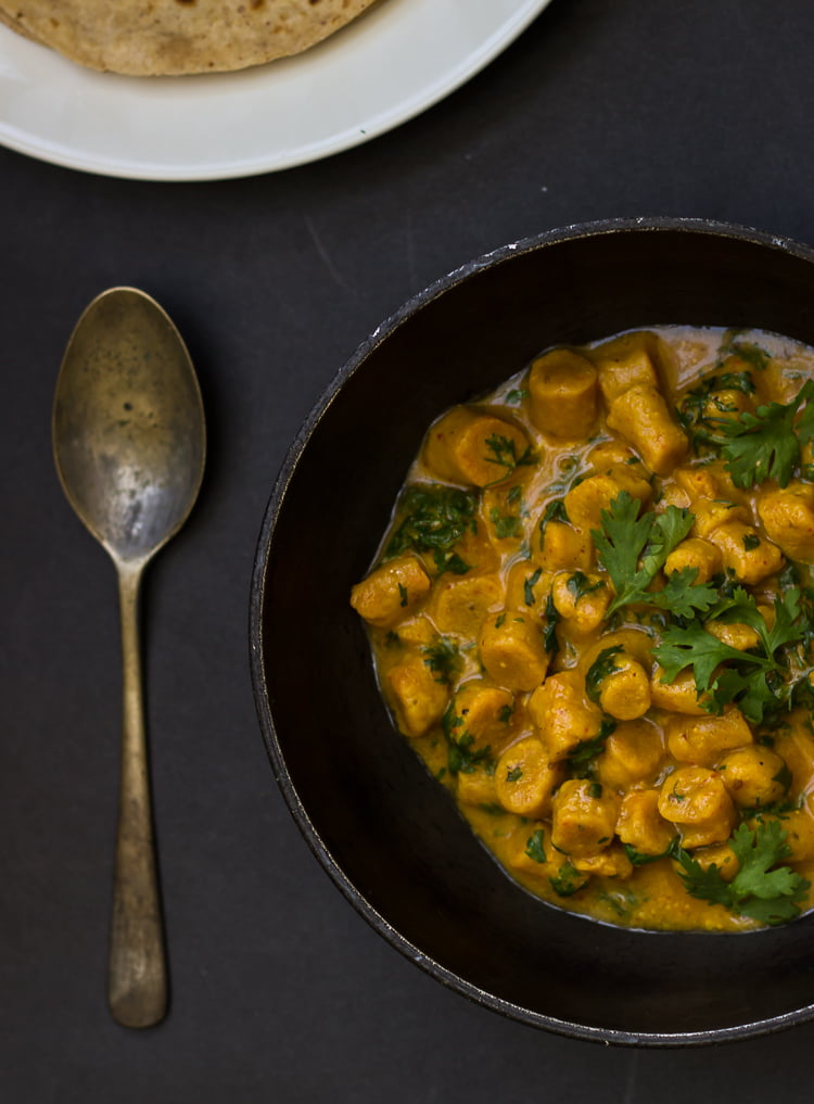 Close-up of Gatte Ki Sabji, highlighting the soft, yellow besan (gram flour) dumplings