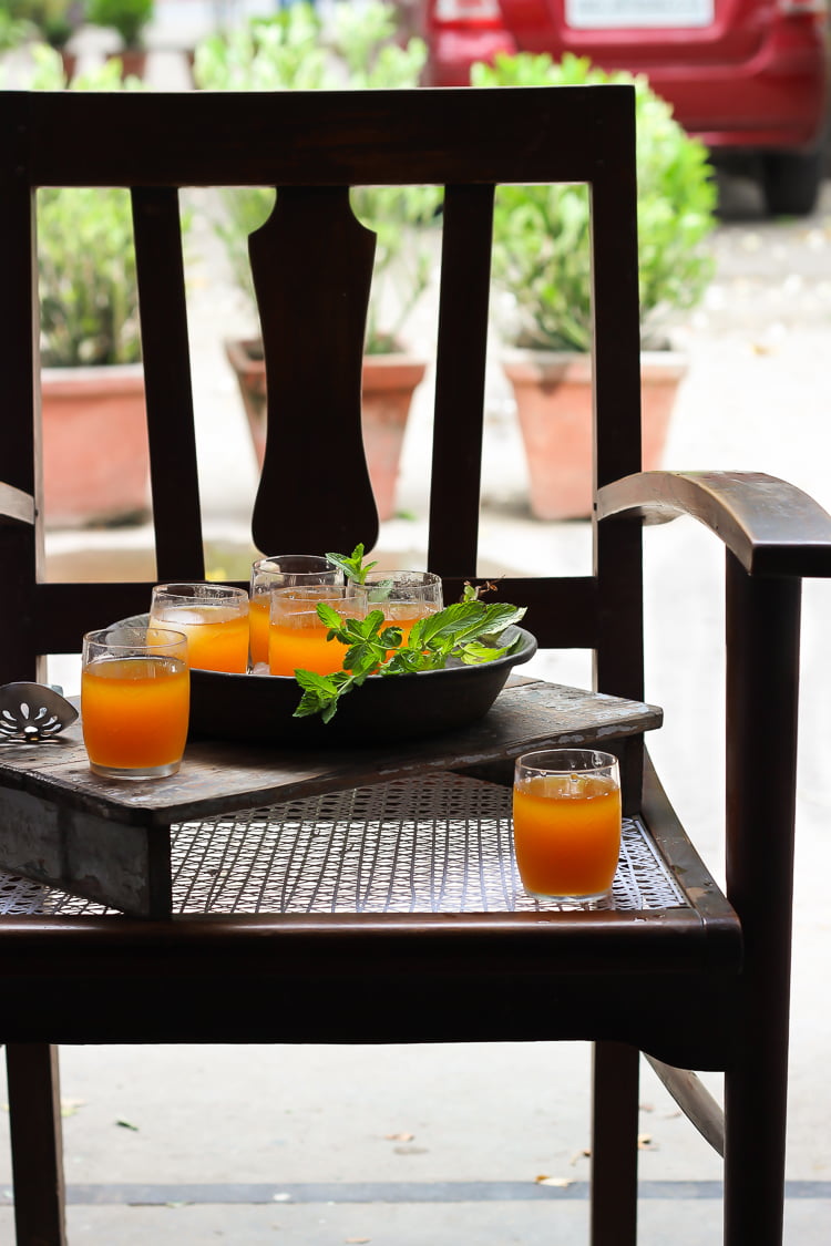 Pouring Bel Ka Sharbat from a jug into a glass, ready to be enjoyed