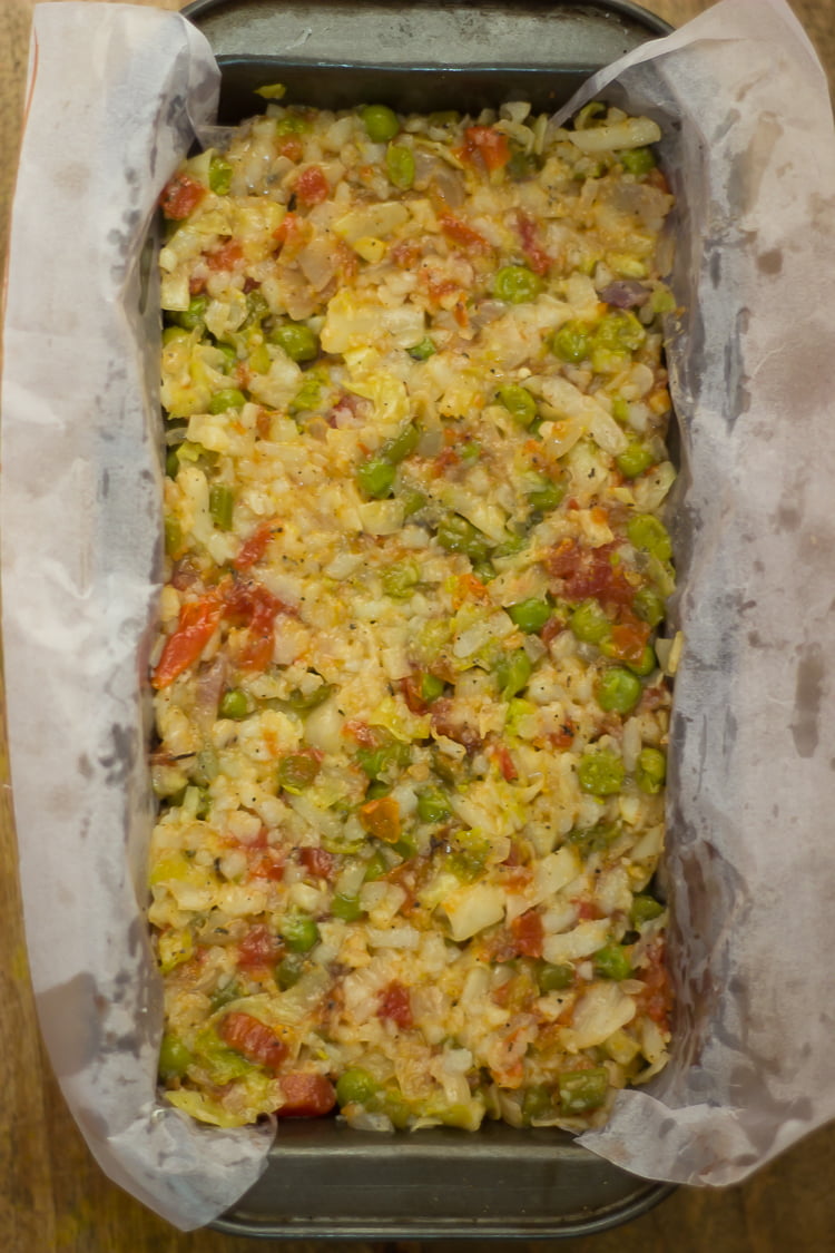 A whole vegetable loaf garnished with chopped vegetables
