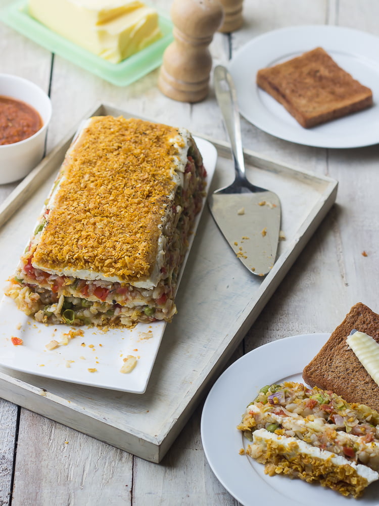 Close-up of the vegetable loaf showing the colorful veggie chunks inside
