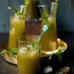 Refreshing glass of Aam Panna served with ice and garnished with fresh mint leaves
