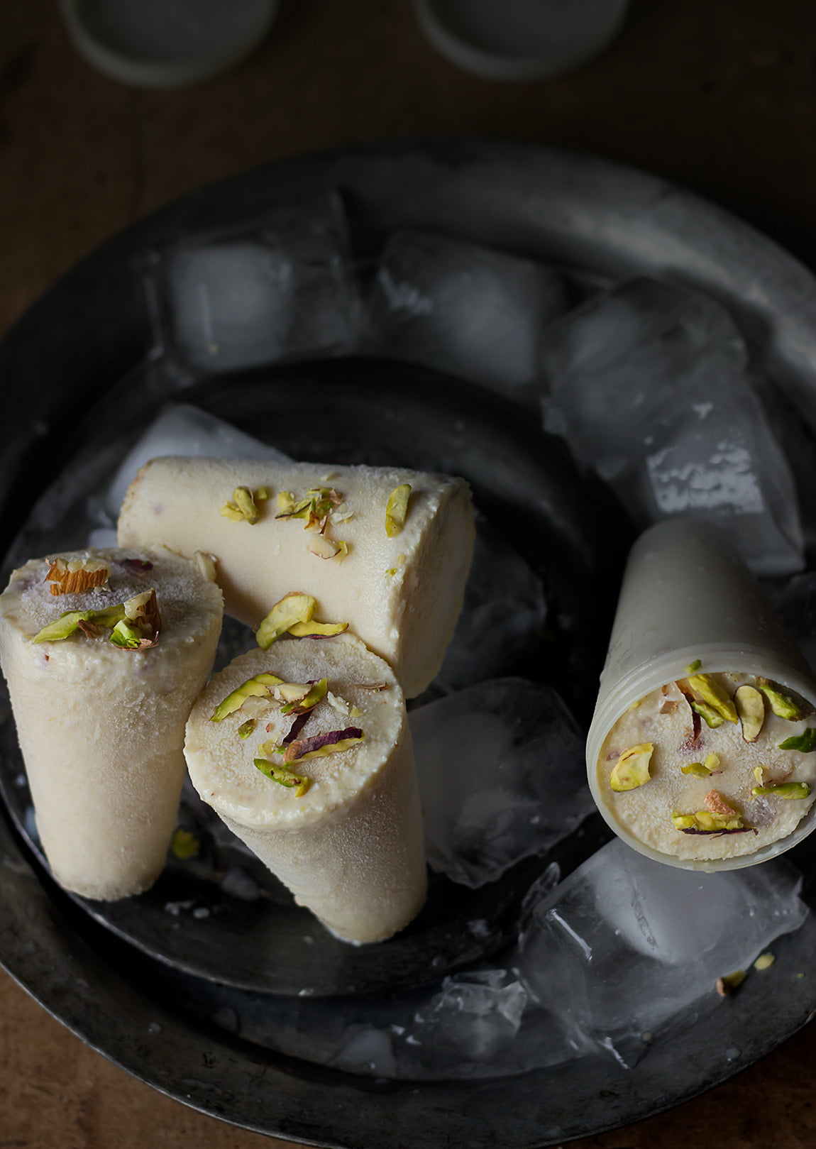 Close-up of Malai Kulfi showing its rich, smooth texture and nutty topping