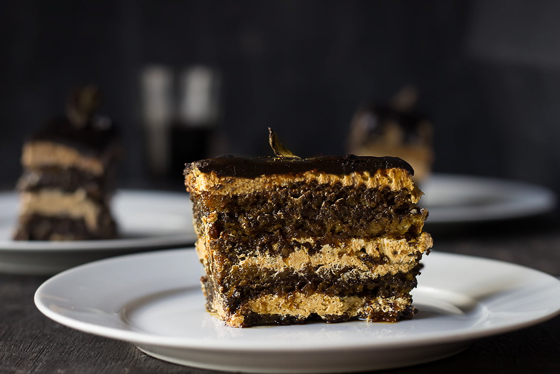 A slice of Eggless French Opera Cake on a plate, ready to be enjoyed