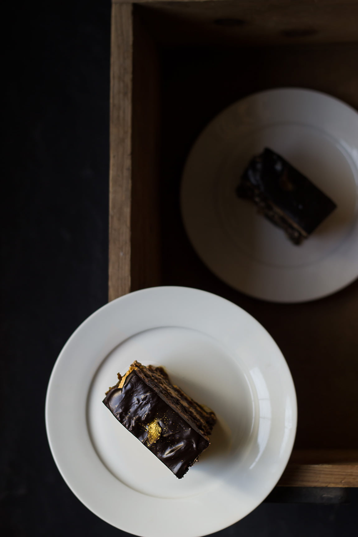 A beautifully garnished Eggless French Opera Cake with a dusting of cocoa powder