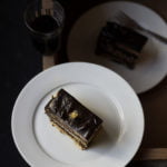 A slice of classic french opera cake served in a white plate