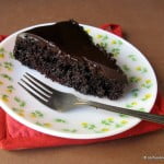 A beautifully plated slice of Sachertorte with a drizzle of chocolate sauce