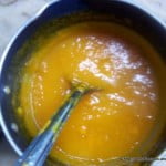 A bowl of mango sauce for the topping on mango cake