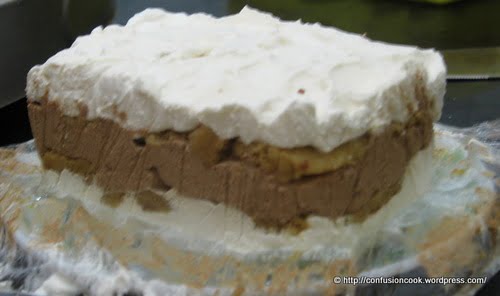 Layering eggless tiramisu in a glass dish with savoiardi and coffee cream