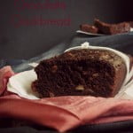 Sliced Healthy Eggless Chocolate Cucumber Banana Bread on a wooden board