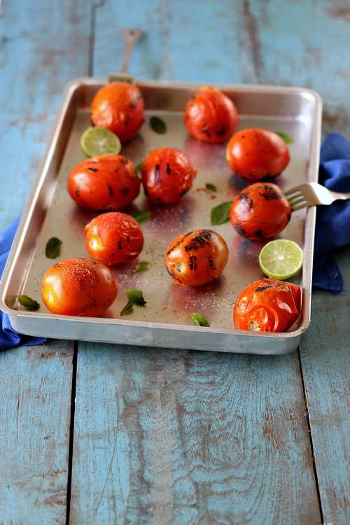 Blanched tomatoes displayed in a tray for peeling