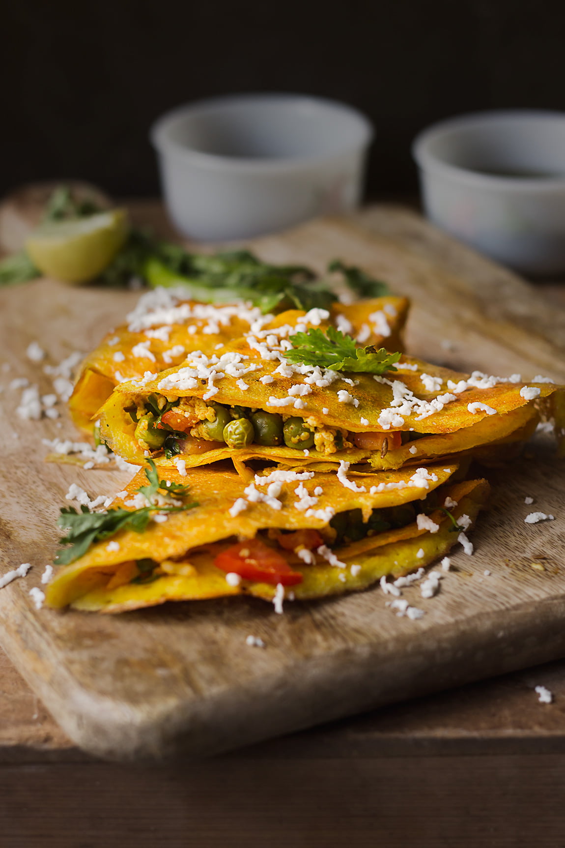 Moong dal chilla garnished with a sprinkle of cumin seeds and fresh coriander