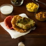 Close up view of palak and beetroot puris