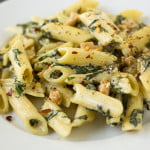 Freshly cooked creamy spinach pasta with a garnish of chilli flakes