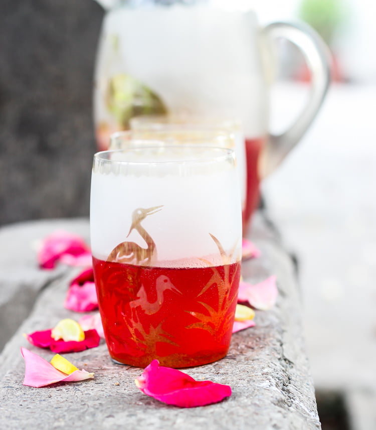 A close-up of the vibrant pink color of Rooh Afza Sharbat in a transparent glass