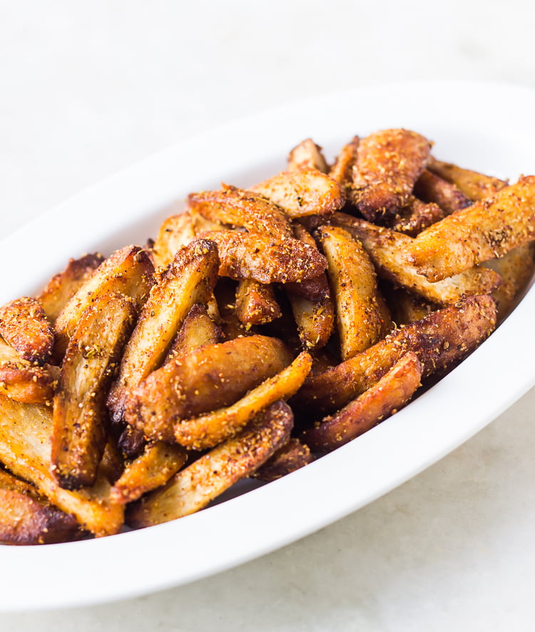 Close-up of crispy Arbi Masala coated with spices and herbs