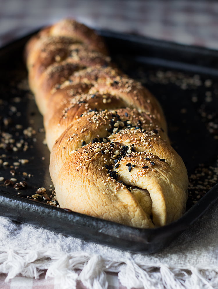 A single slice of challah bread topped with sesame seeds
