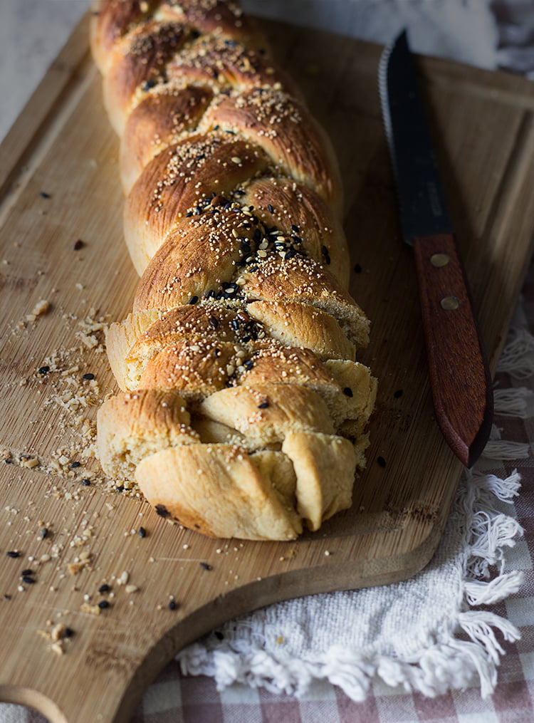 Golden, shiny challah loaf with a crisp crust just removed from the oven