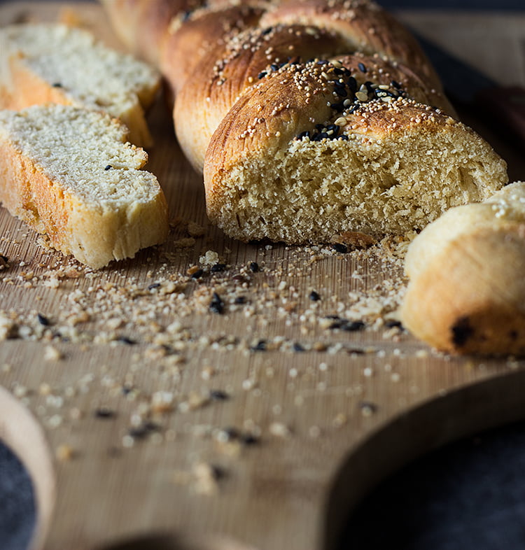 Freshly baked challah with a golden-brown crust sprinkled with poppy seeds
