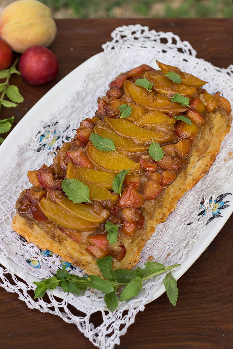 Golden peach and plum upside-down cake with caramelized fruit topping