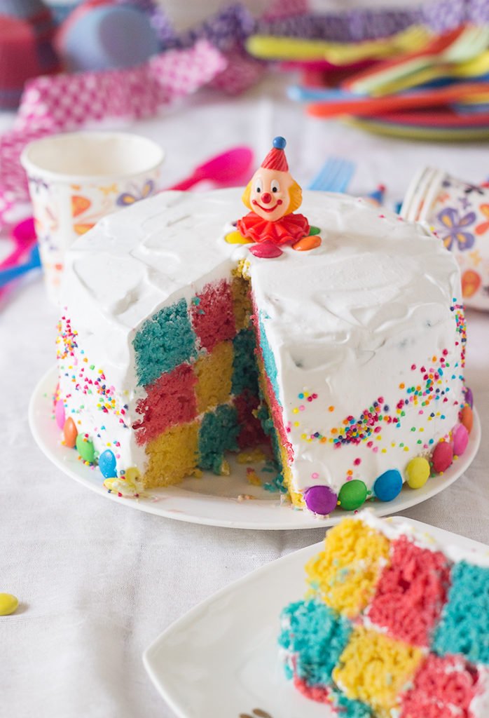 A vibrant Rainbow Checkerboard Cake showing its colorful layers
