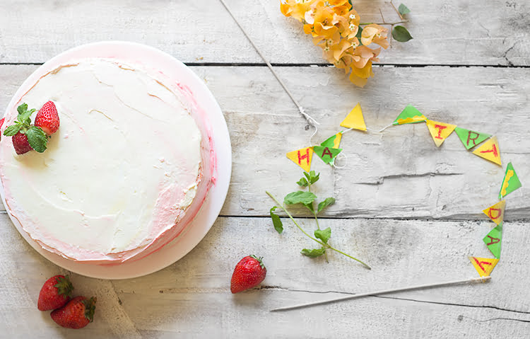 Eggless Strawberry Ombre Cake topped with fresh strawberries and cream