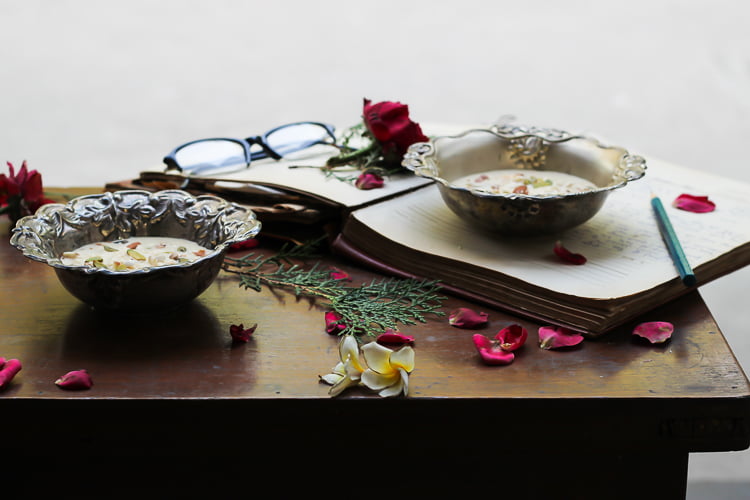 Malai Rabri garnished with rose petals, served in a traditional Indian bowl