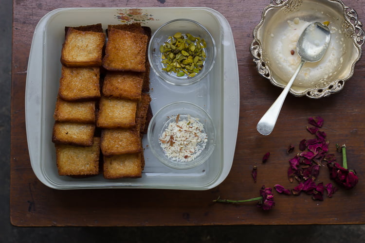 Ingredients for Shahi Tukda, including bread slices, sugar, milk, and nuts