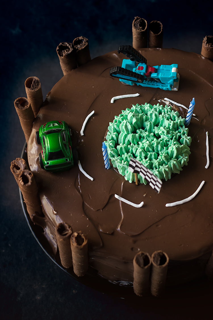 Top view of a homemade race track cake, showcasing the entire layout and decorations