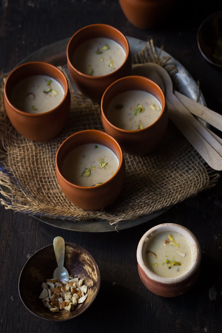 Pearl Millet Pudding served in a decorative pot with a side of almonds