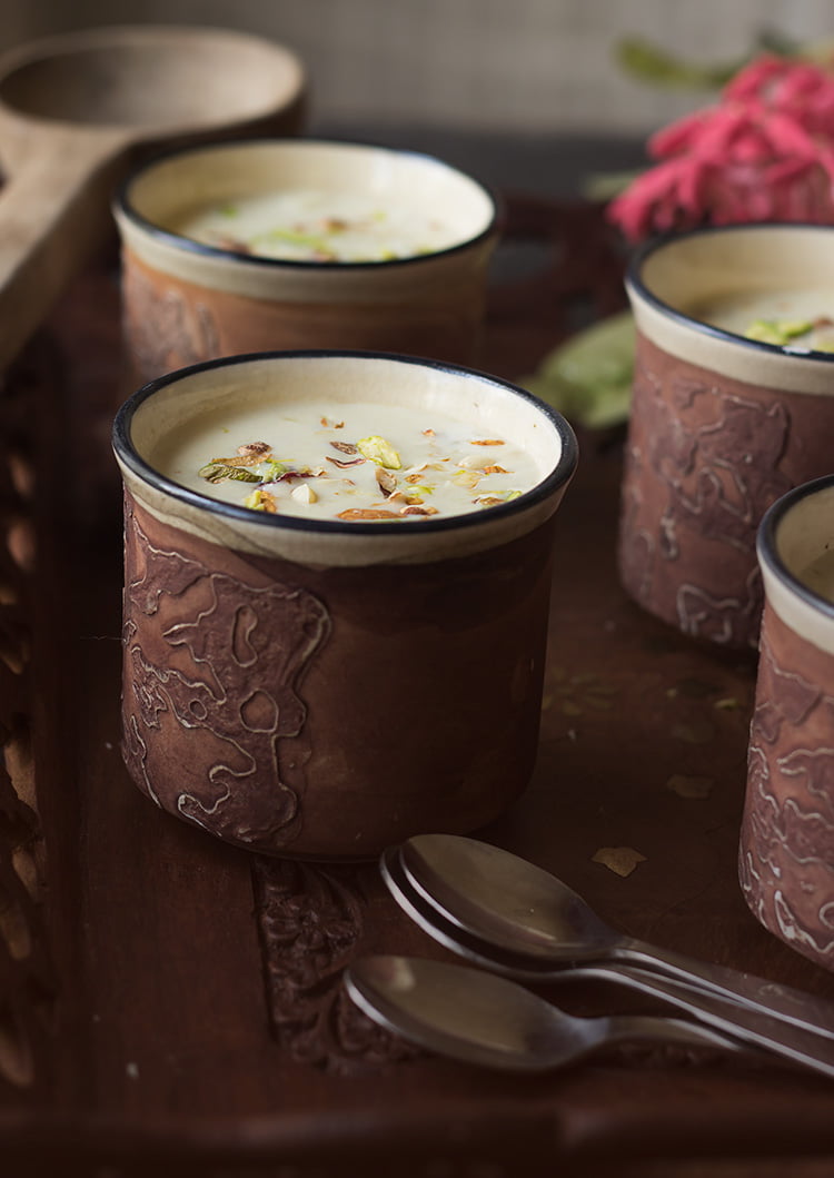 Gur ki Kheer served in a traditional clay pot with a spoon beside it