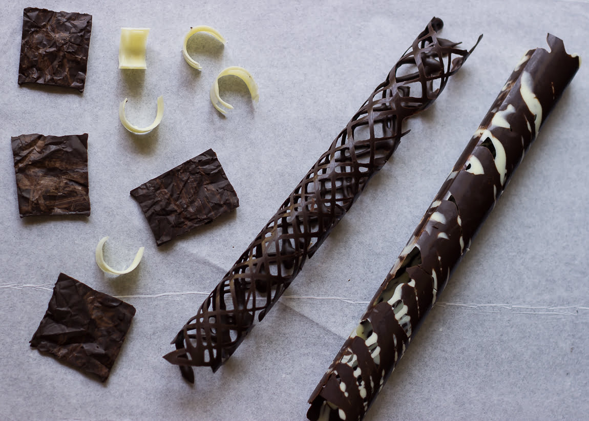 Ingredients for no-bake biscuit cake: chocolate bars, butter, and biscuits on a countertop