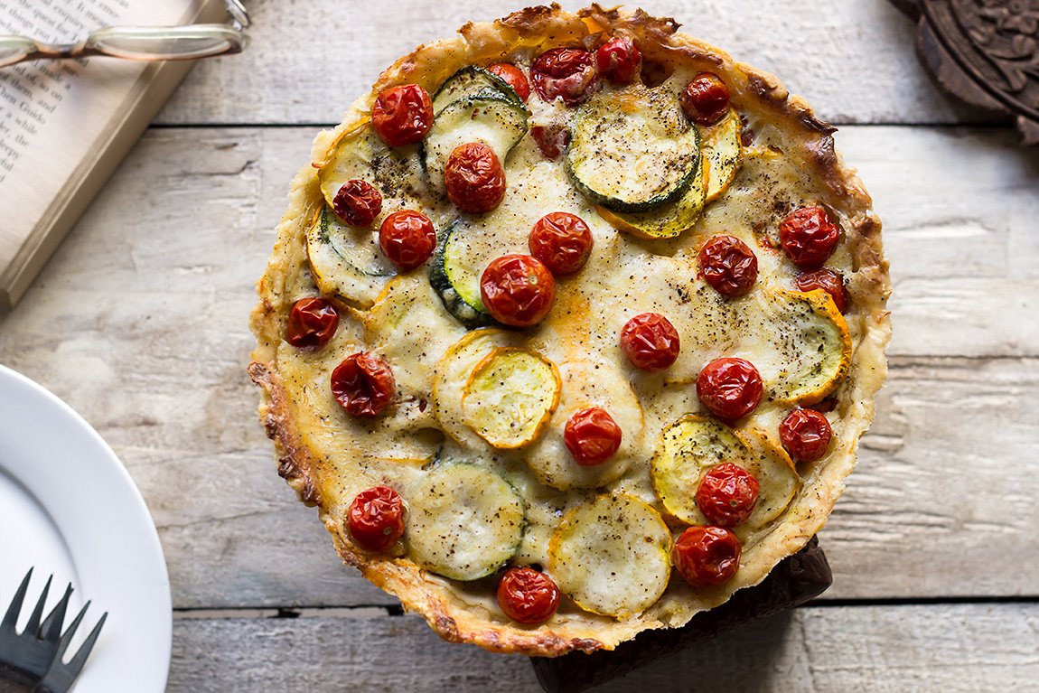 Freshly baked Tomato Zucchini Tart with golden crust and vibrant vegetable topping