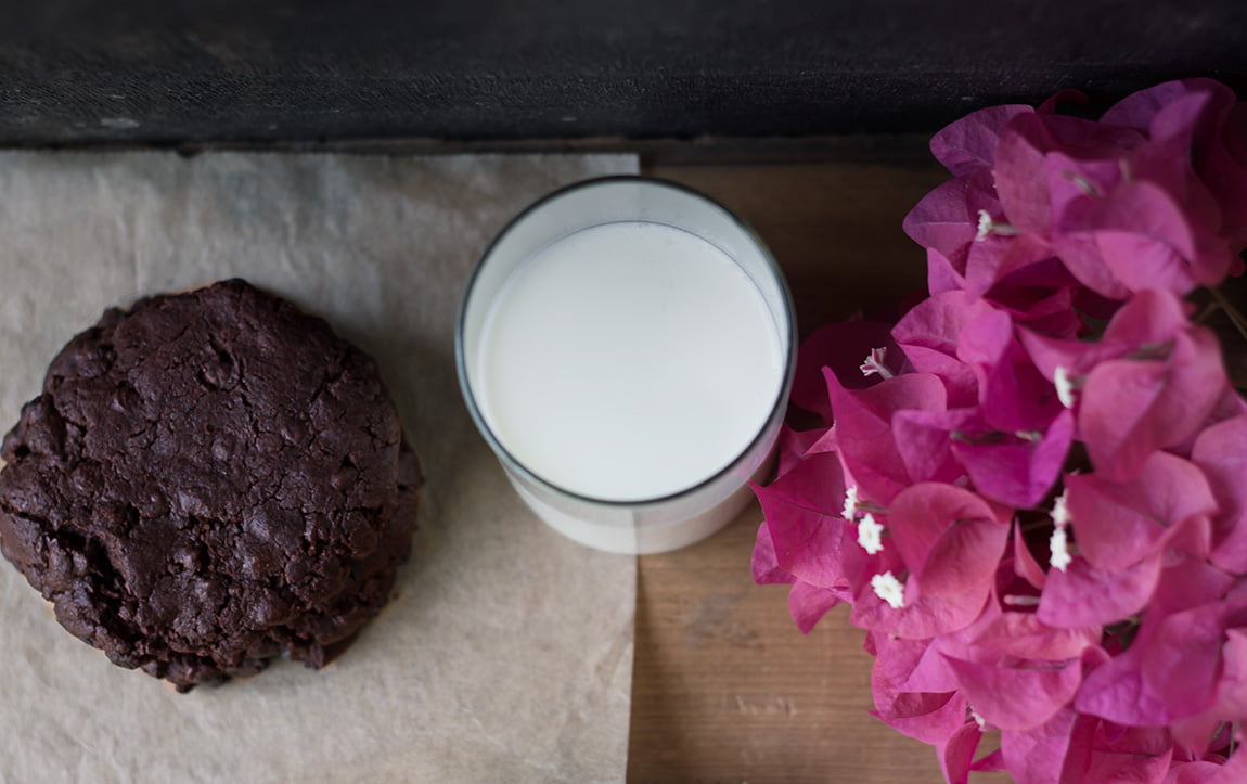 A close-up of a crispy edge and soft center of a double chocolate cookie