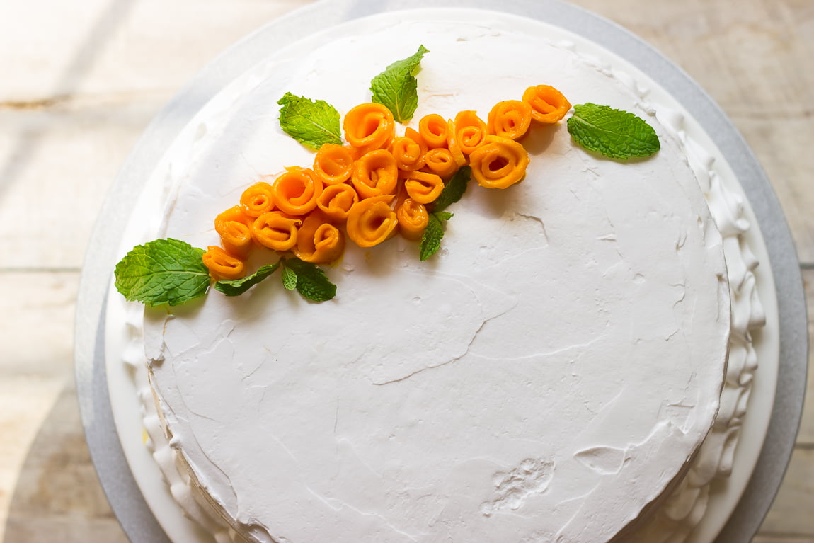 Fresh mango petals arranged in a circular pattern on top of the mango rose cake