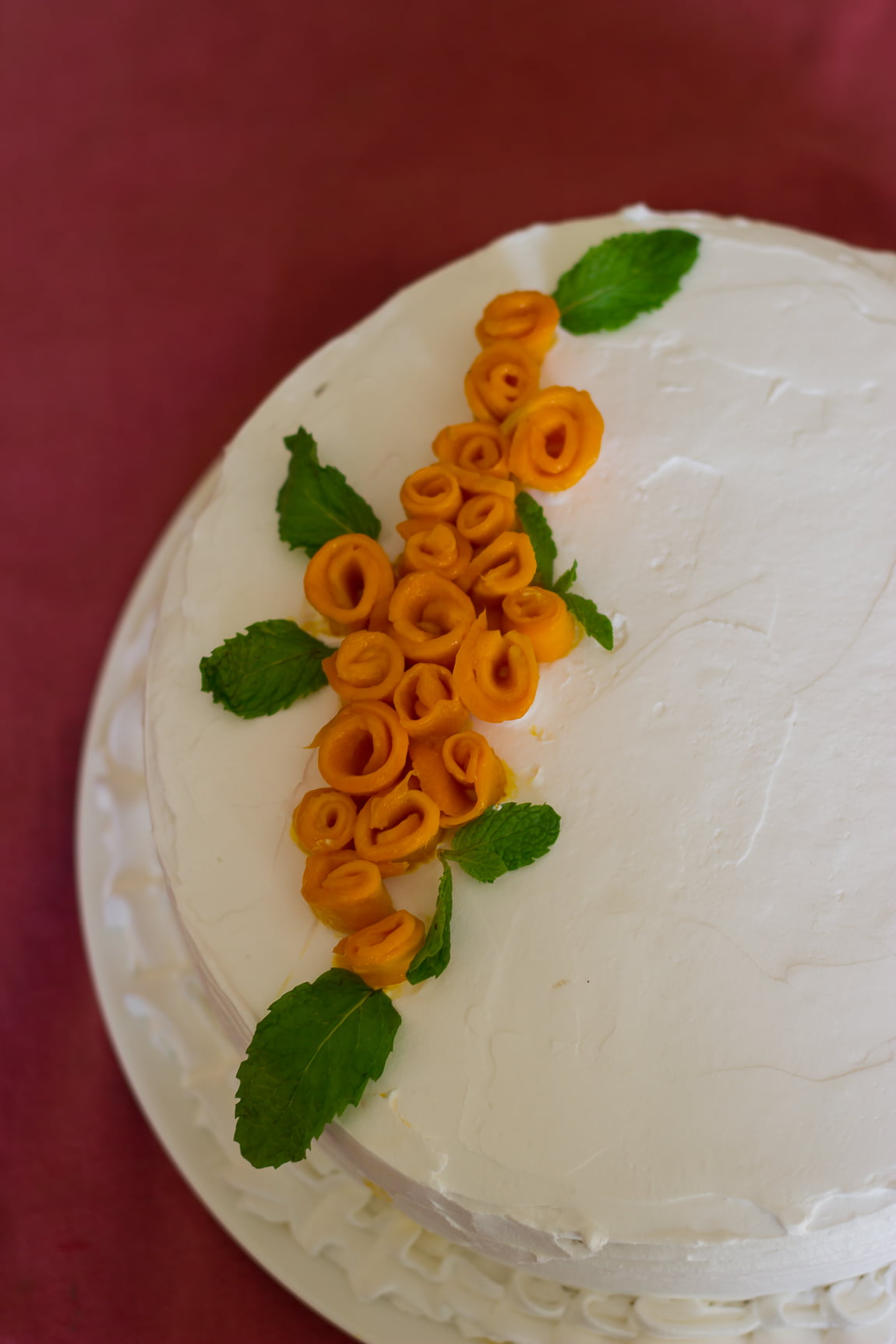 Close-up of the moist eggless mango cake topped with whipped cream