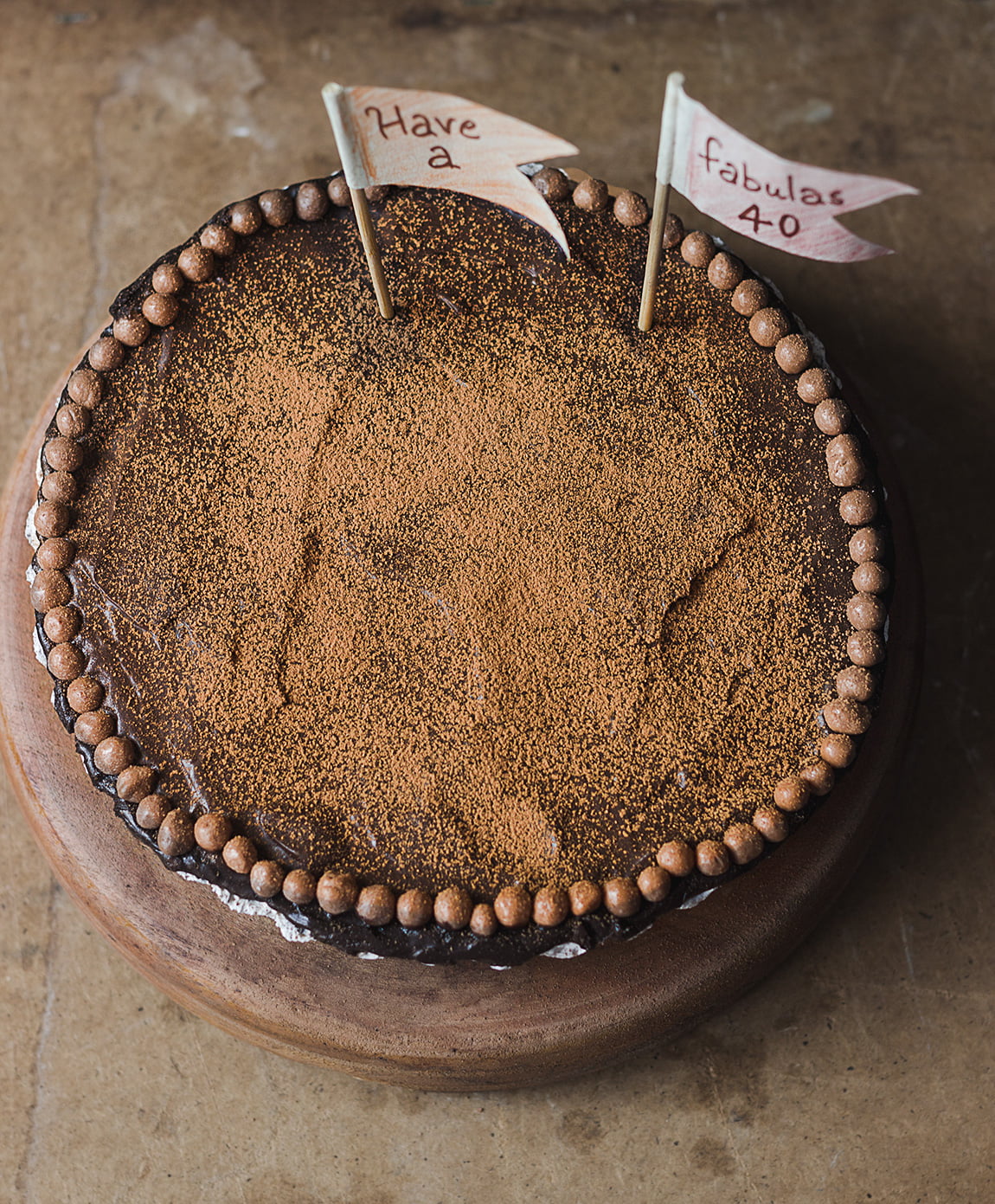 A decorated No-Bake Chocolate Mousse Cake garnished with the chocolate balls at the side