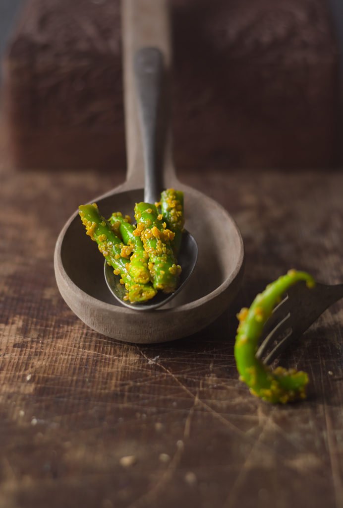 A close-up shot of vibrant green chilli pickle showcasing its spicy and tangy texture