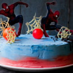Close-up of the homemade Spiderman cake, showing the vibrant layers and intricate webbing detail