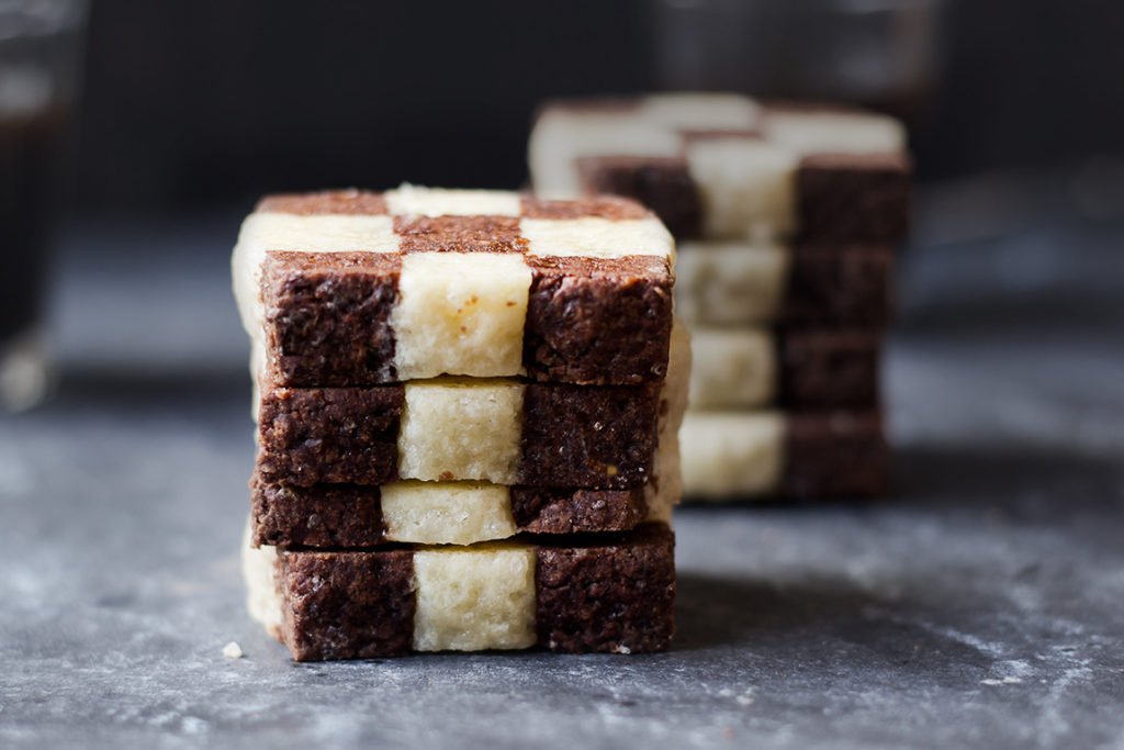Close-up of freshly baked checkerboard cookie with vanilla and chocolate squares