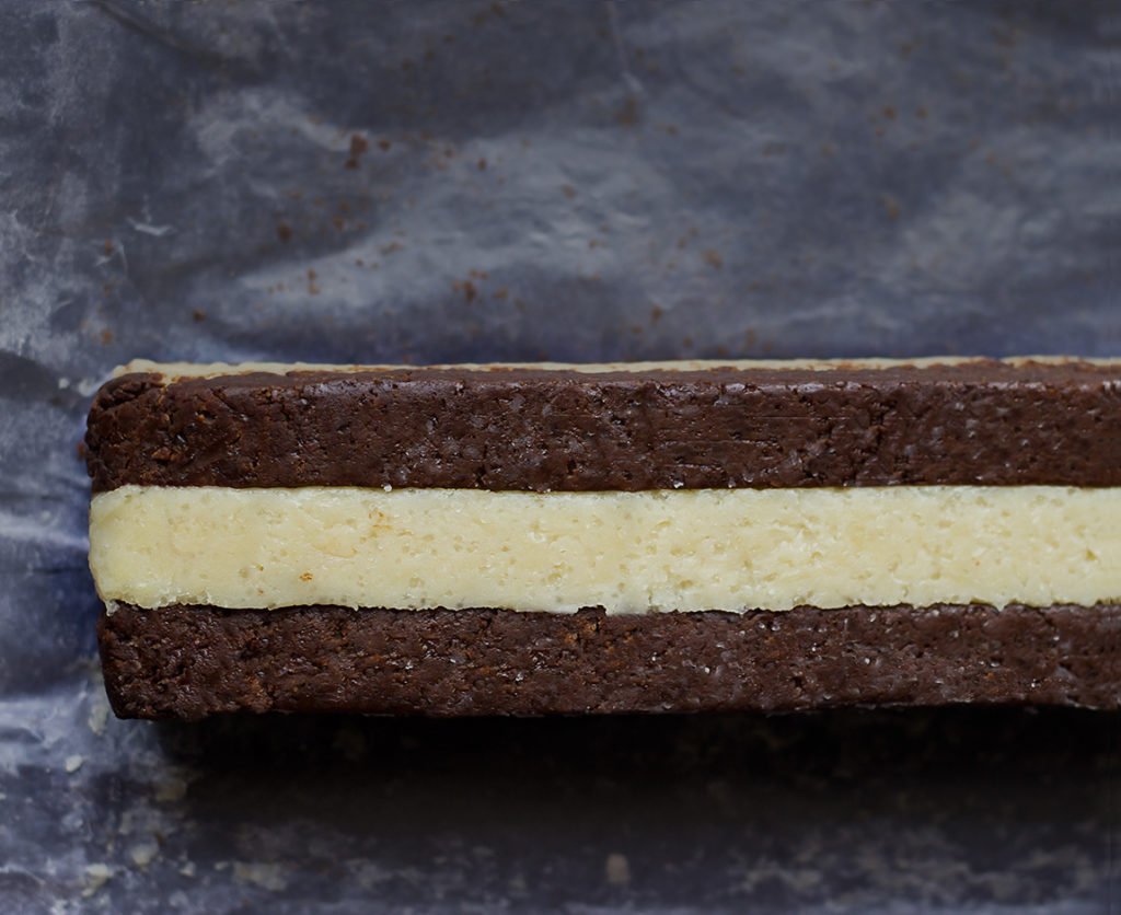 Checkerboard cookie dough being shaped on a baking sheet
