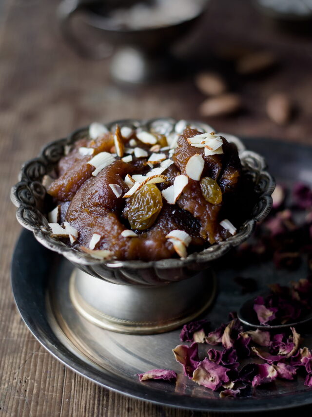 A bowl of freshly made Aate Ka Halwa garnished with almonds and pistachio