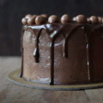 A classic Old Fashioned Chocolate Cake with smooth chocolate frosting and chocolate balls on top