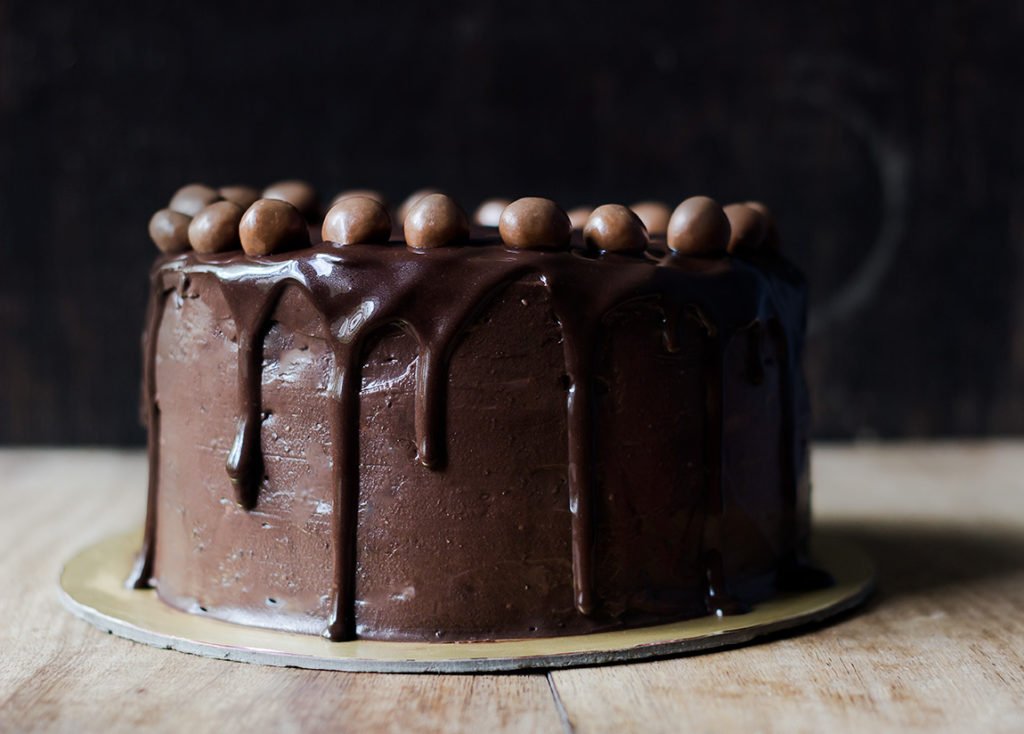 A whole Old Fashioned Chocolate Cake on a cake stand, ready to be served