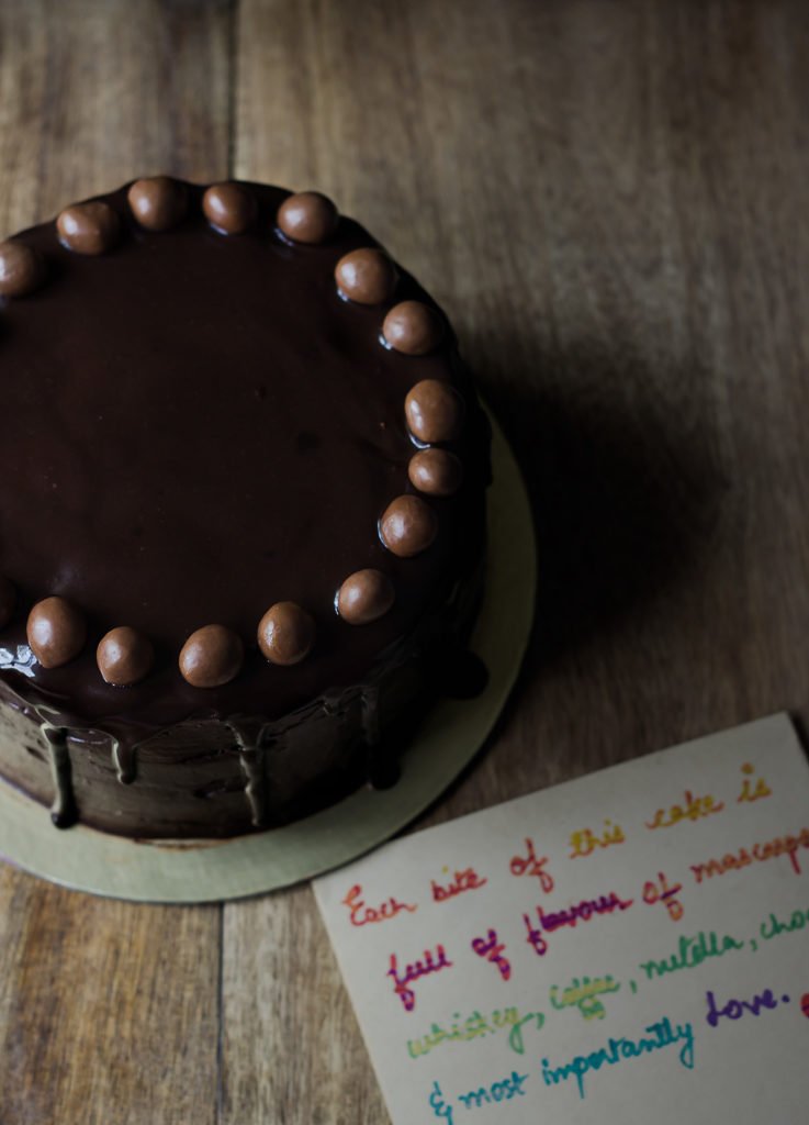 A beautifully decorated Old Fashioned Chocolate Cake with chocolate balls on top