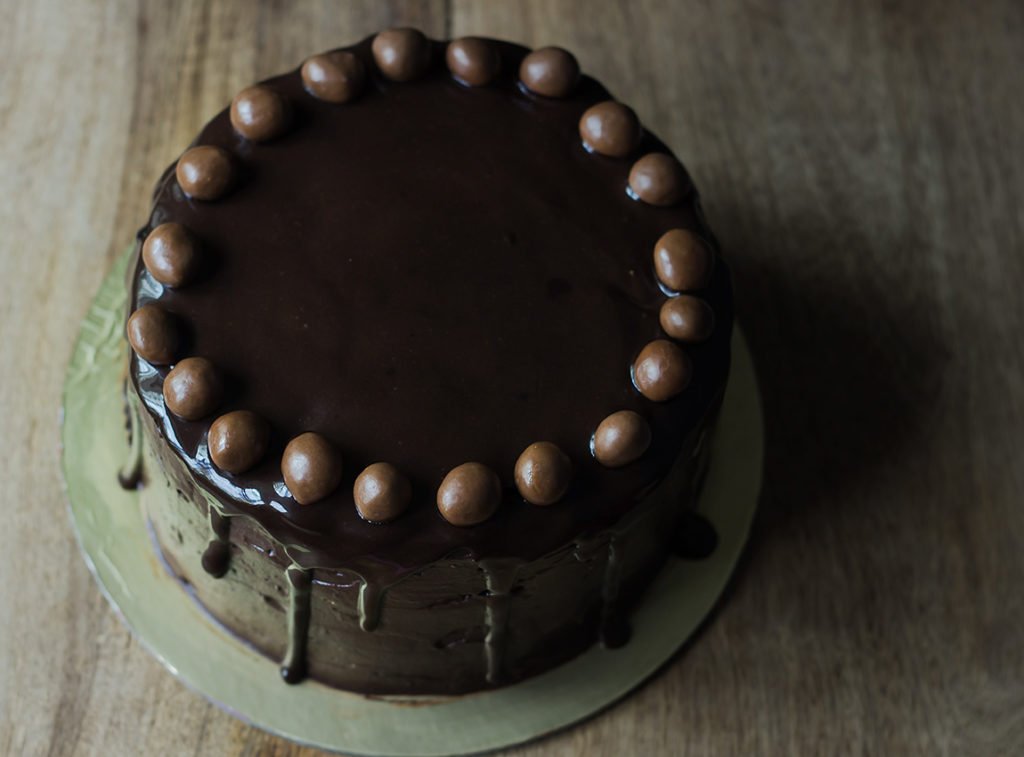 Close-up of a slice of Old Fashioned Chocolate Cake, showcasing its rich frosting