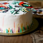 Moist and fluffy eggless hand-painted cake on a plate, highlighting the rich texture and detailed artwork