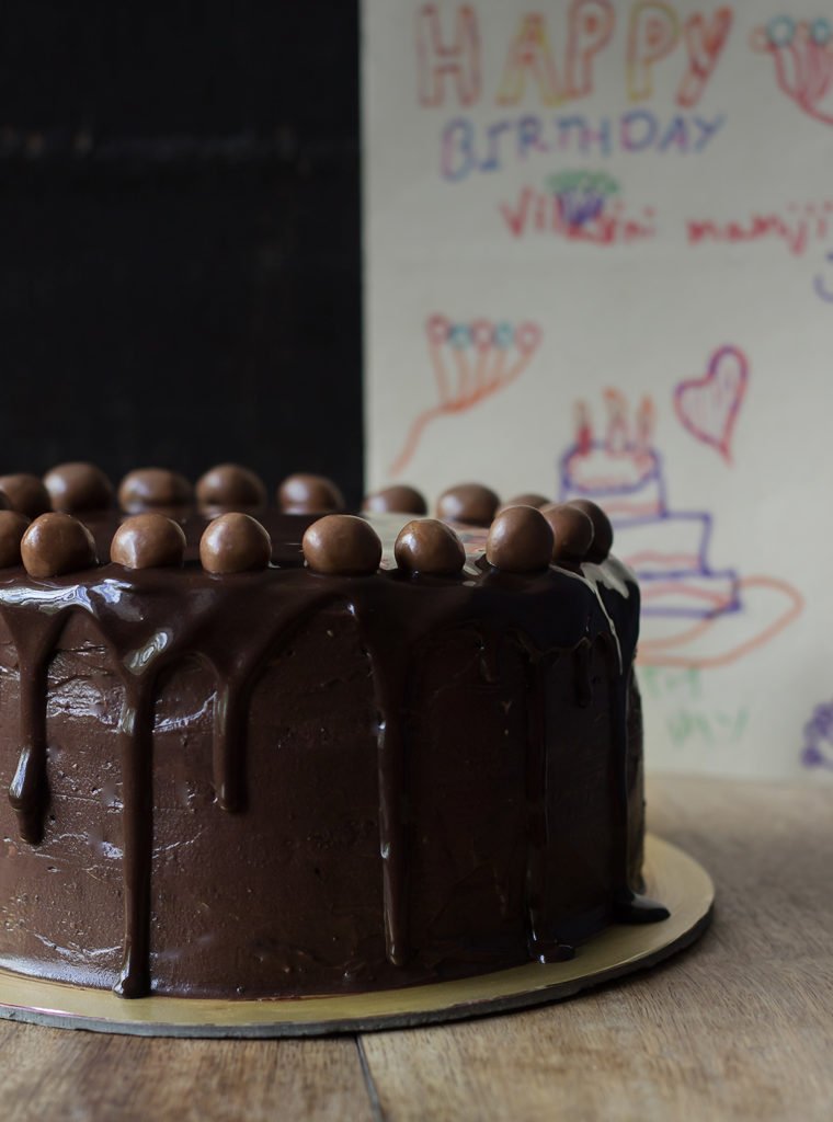 A classic Old Fashioned Chocolate Cake with smooth chocolate frosting and chocolate balls on top