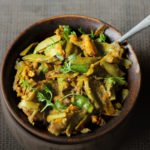 A bowl full of freshly cooked Gawar Phali Ki Sabji, garnished with cilantro