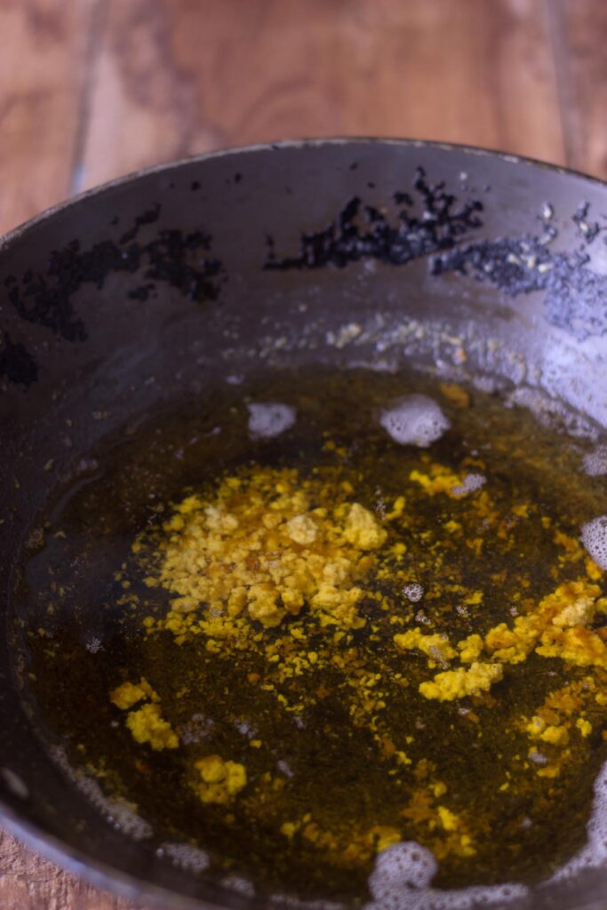 Close-up of browned milk solids settling at the bottom of the pan