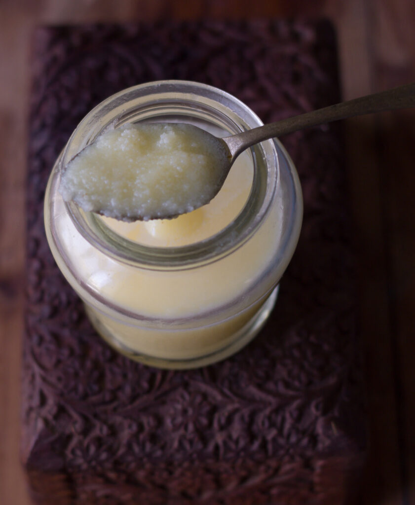 A spoonful of the finished ghee, showcasing its smooth texture